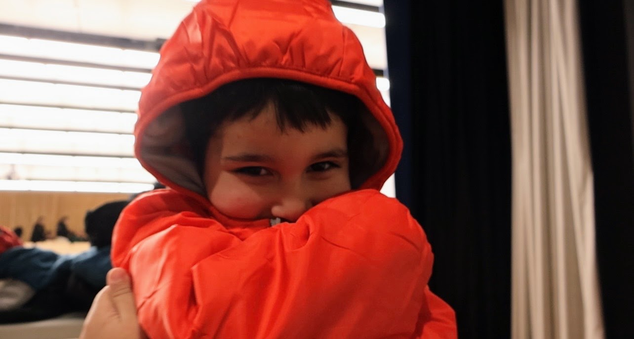 Kid in brand-new coat from Operation Warm